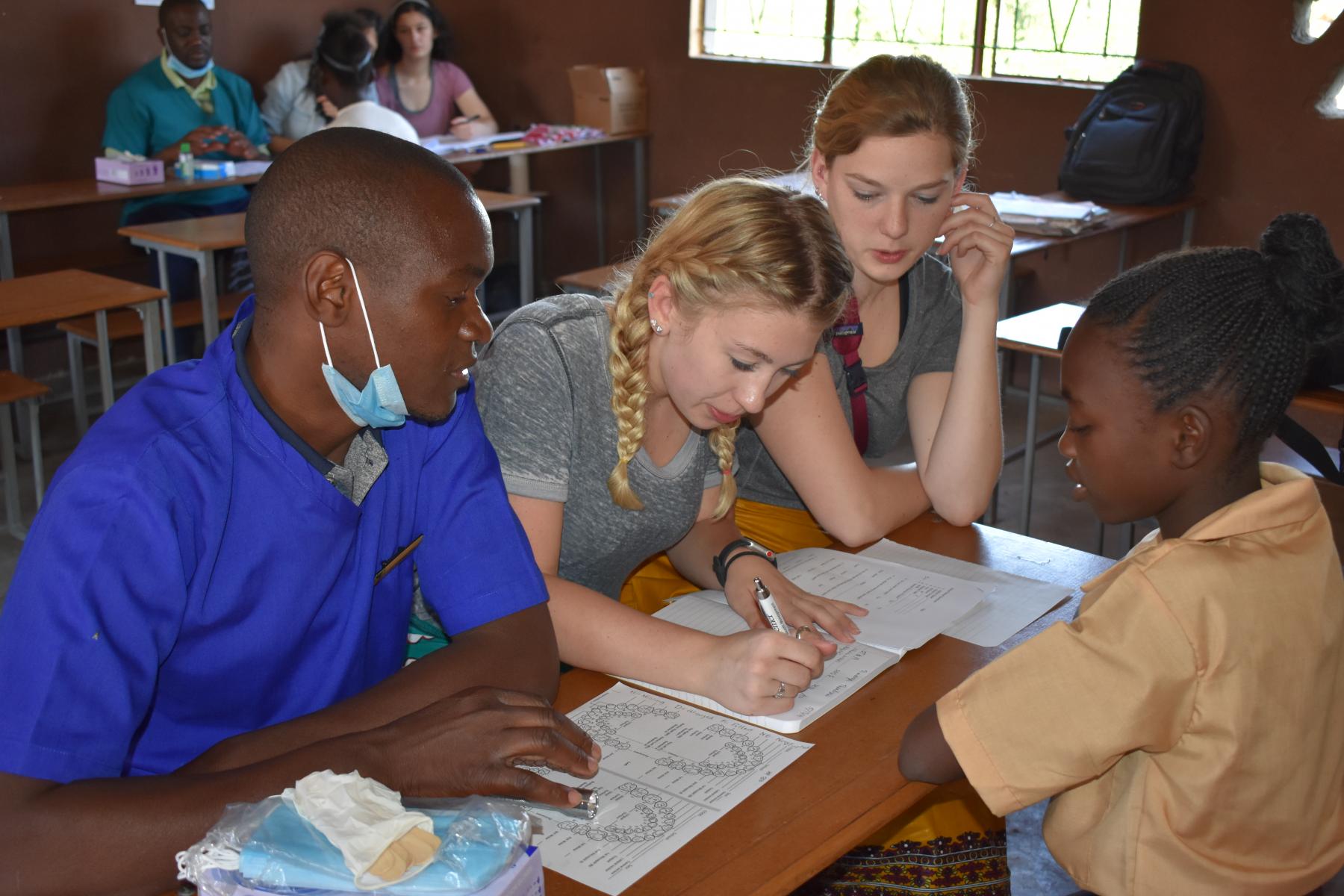Students conducting research in a school in Africa.